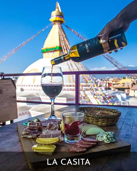 Meal being served at La casita Restaurant's table, with view of Boudhanath Stupa